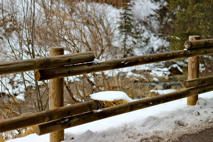 wooden fence at the waterside in canazei